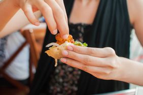 Woman eating spicy shrimp fajita