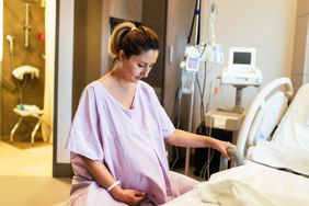 pregnant woman in the hospital ward sitting on fitness ball and ready to delivery a baby