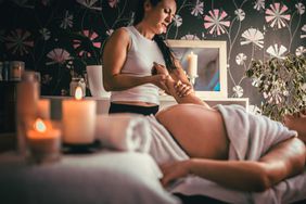 Pregnant woman having massage in spa