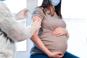 Pregnant person receiving a vaccination