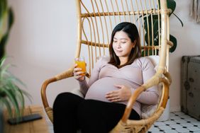 Pregnant woman drinking a beverage