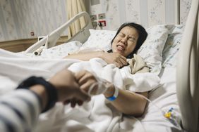 pregnant woman feeling labor pain in a hospital bed