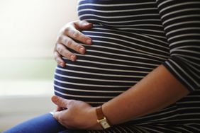 Pregnant woman holding her belly