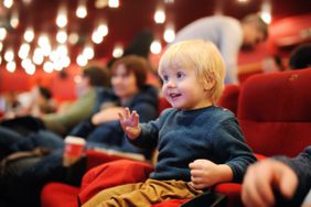 Toddler sitting in a movie theater