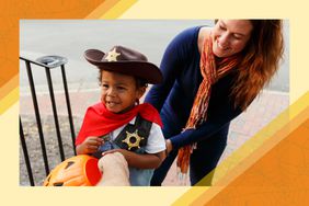 Mom encouraging young child on halloween 