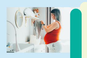 Pregnant mom folding baby clothes in a nursery