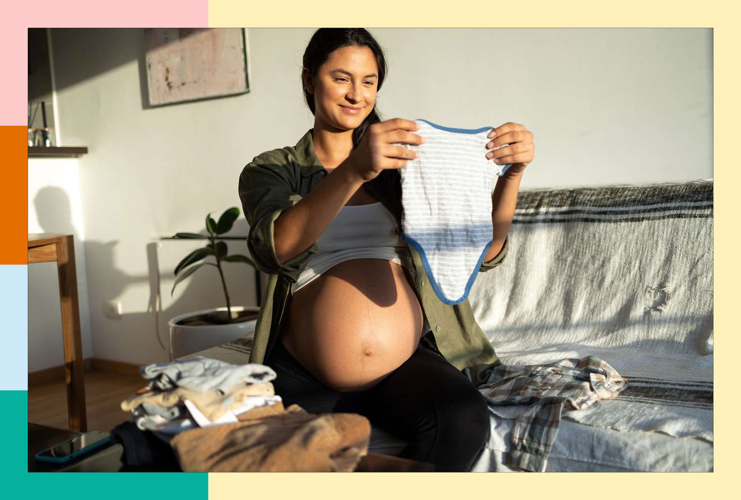 Pregnant mom folding baby vlothes 