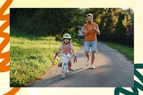 dad encouraging daughter to ride a bike