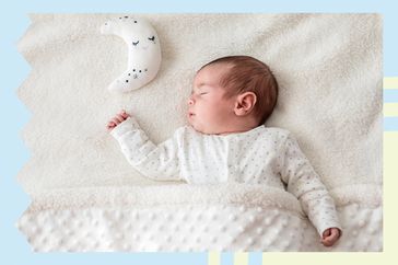 Baby laying with a moon shaped pillow