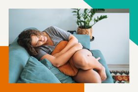 Woman having cramps on the couch 