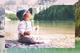 Baby sitting on the shore of a lake.