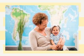 Mom holding daughter in front of a world map 