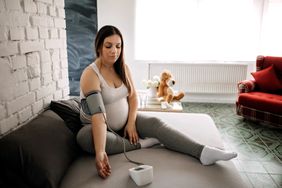 Pregnant women measuring blood pressure