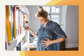 a pregnant woman standing beside a bookshelf 