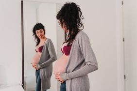 pregnant woman looking at body