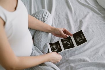 Women looking at her ultrasound photos