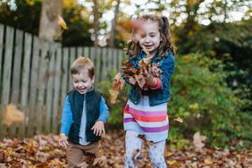 Kids play with leaves outside