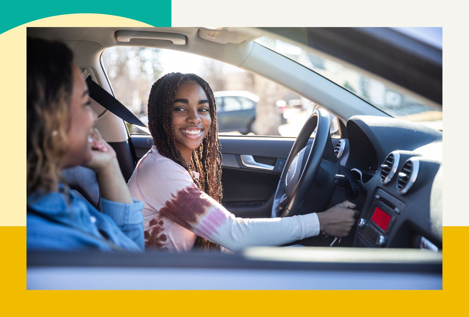 Teen girl in the driver's seat of a car looking at her mother in the passenger seat.