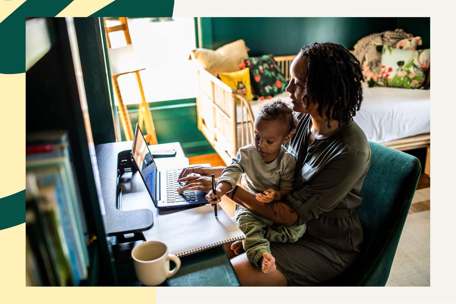 Woman working from home while holding toddler