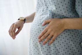 Pregnant person timing contractions in hospital