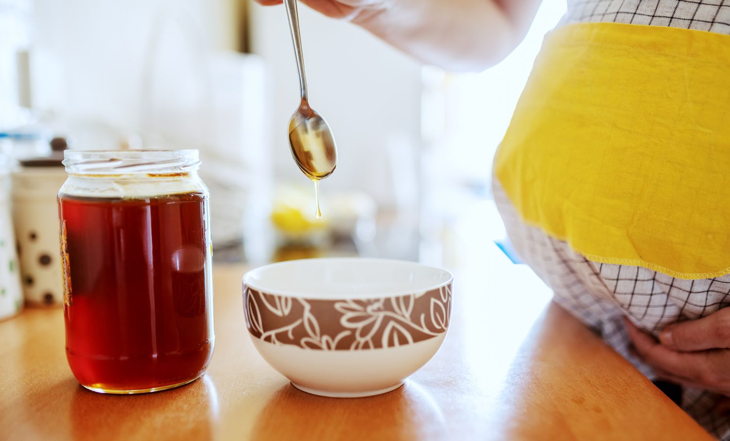 Pregnant woman eating honey