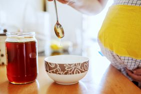 Pregnant woman eating honey