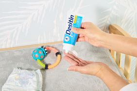 Two hands posing with the Desitin Daily Defense Cream tube