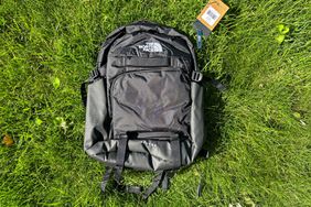 The The North Face Router Backpack in grass with the tags on