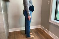 A pregnant person wearing the 1822 Maternity Better Butter Slim Straight With Bellyband