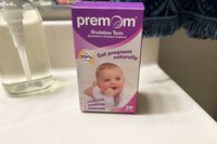 Premom Quantitative Ovulation Test Strips box on a bathroom counter