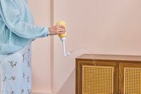 A person sprays water from the peri bottle included in the Sunflower Motherhood Deluxe Postpartum Recovery Box