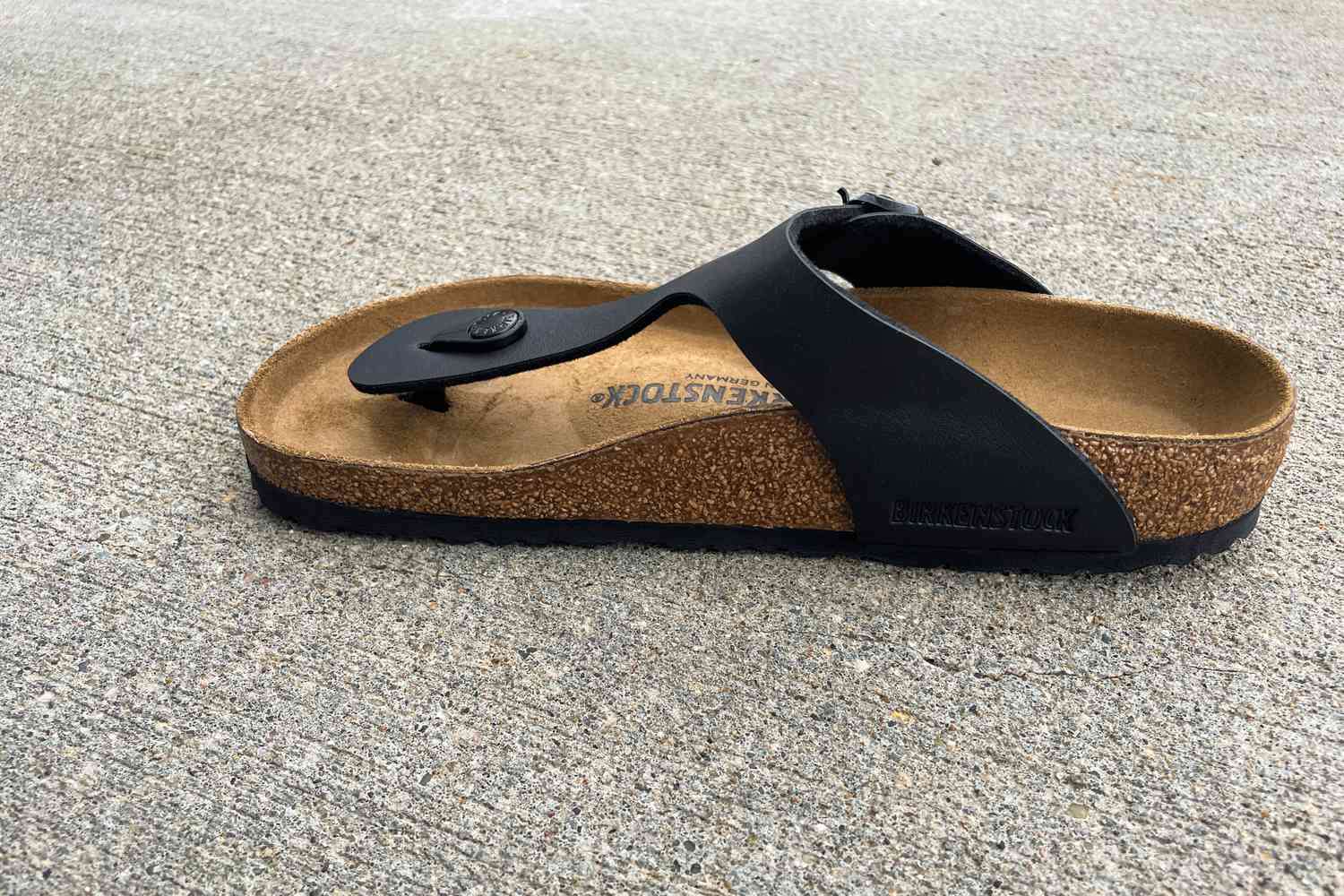 The Birkenstock Gizeh Birko-Flor Sandals on concrete