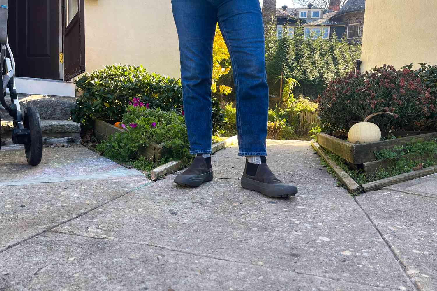 A close-up of a person outdoors while wearing the SeaVees Ballard Boots on concrete