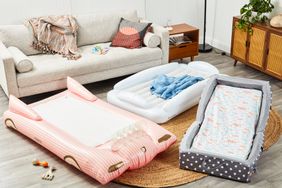 Three toddler travel beds on a living room floor.