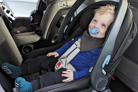 A child sits in the Peg Perego PRIMO VIAGGIO 4-35 Atmosphere car seat