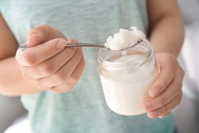 Spoon Scoop of Coconut Oil From Jar Glass