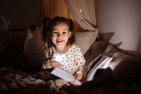 Smiling girl with bedtime story