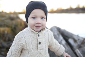 Baby with blue eyes in sweater.