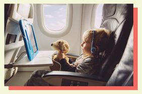 Child holding a stuffed animal while watching a tablet on an airplane.