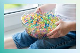 Image of a child holding a bowl of water beads.