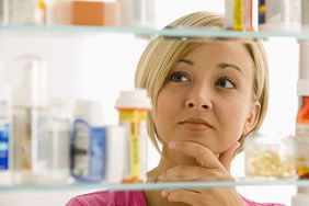 Women looking into medicine cabinet