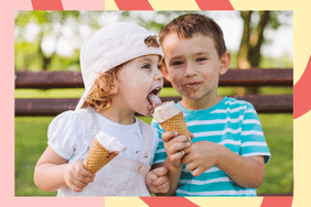 two toddlers a boy and a girl bot heating ice cream cones and the little girl is taking a lick of the boy's ice cream cone