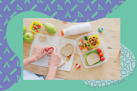 Overhead view of hands making a packed lunch