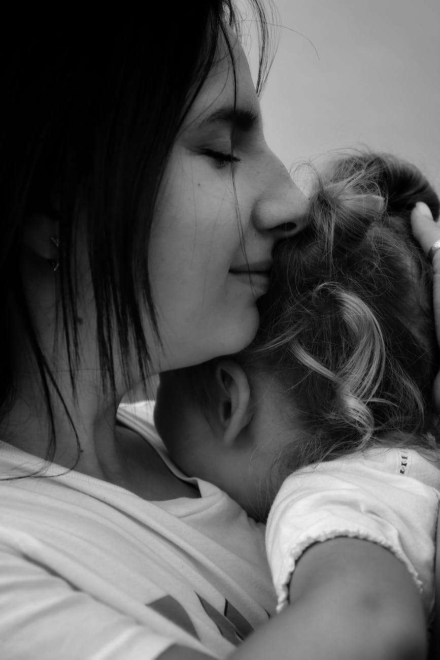 mother hugging daughter in black and white